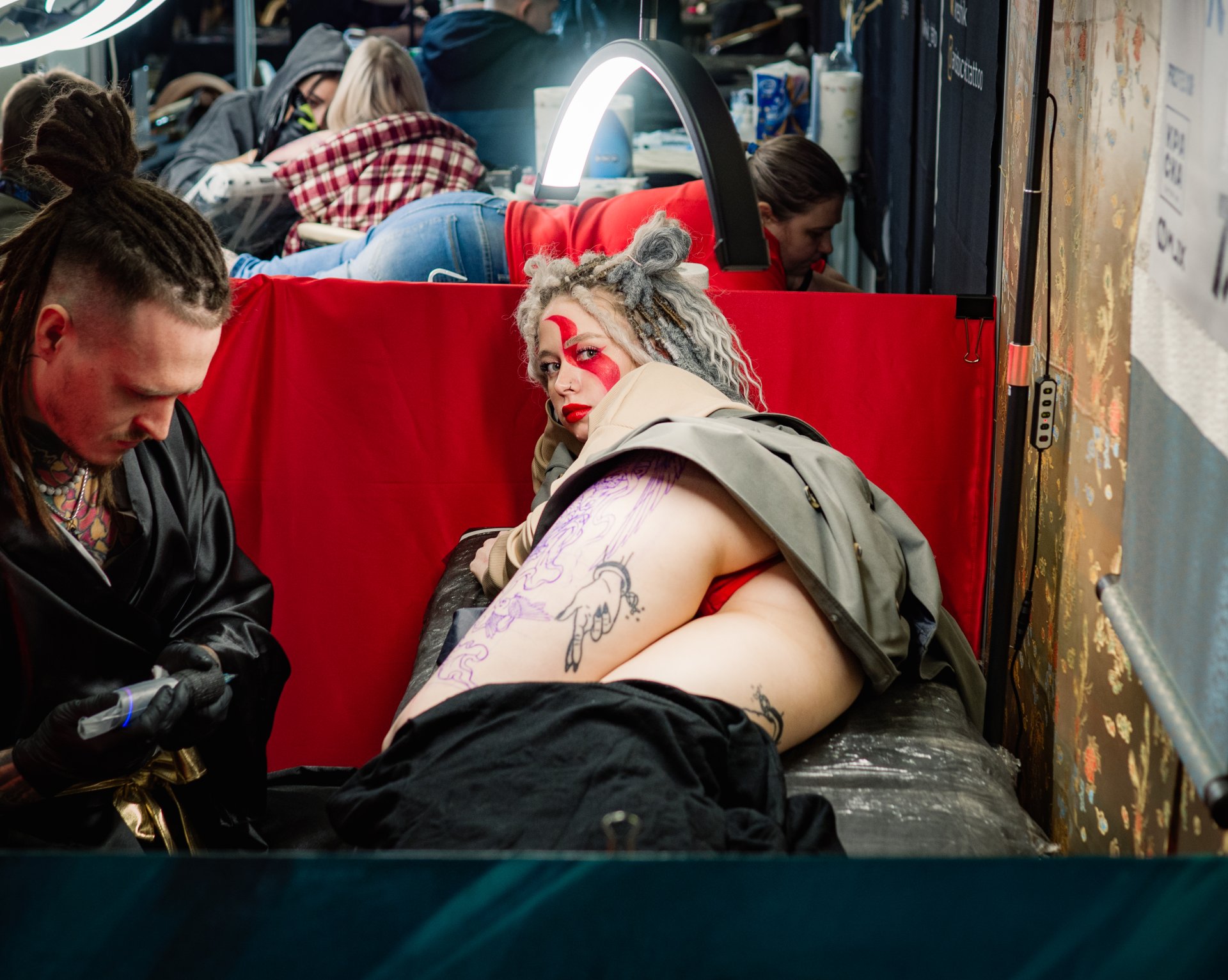 The process of tattooing. Some large and voluminous tattoos are done by masters for several months. This is a very difficult and time-consuming creative process.