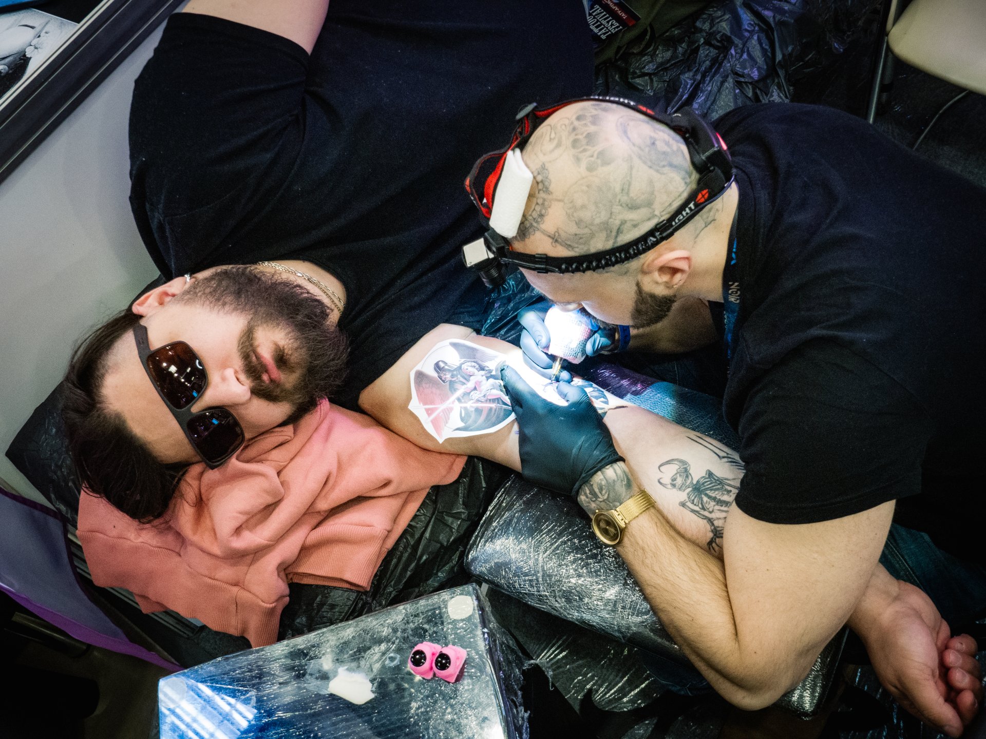 The process of tattooing. Some large and voluminous tattoos are done by masters for several months. This is a very difficult and time-consuming creative process.