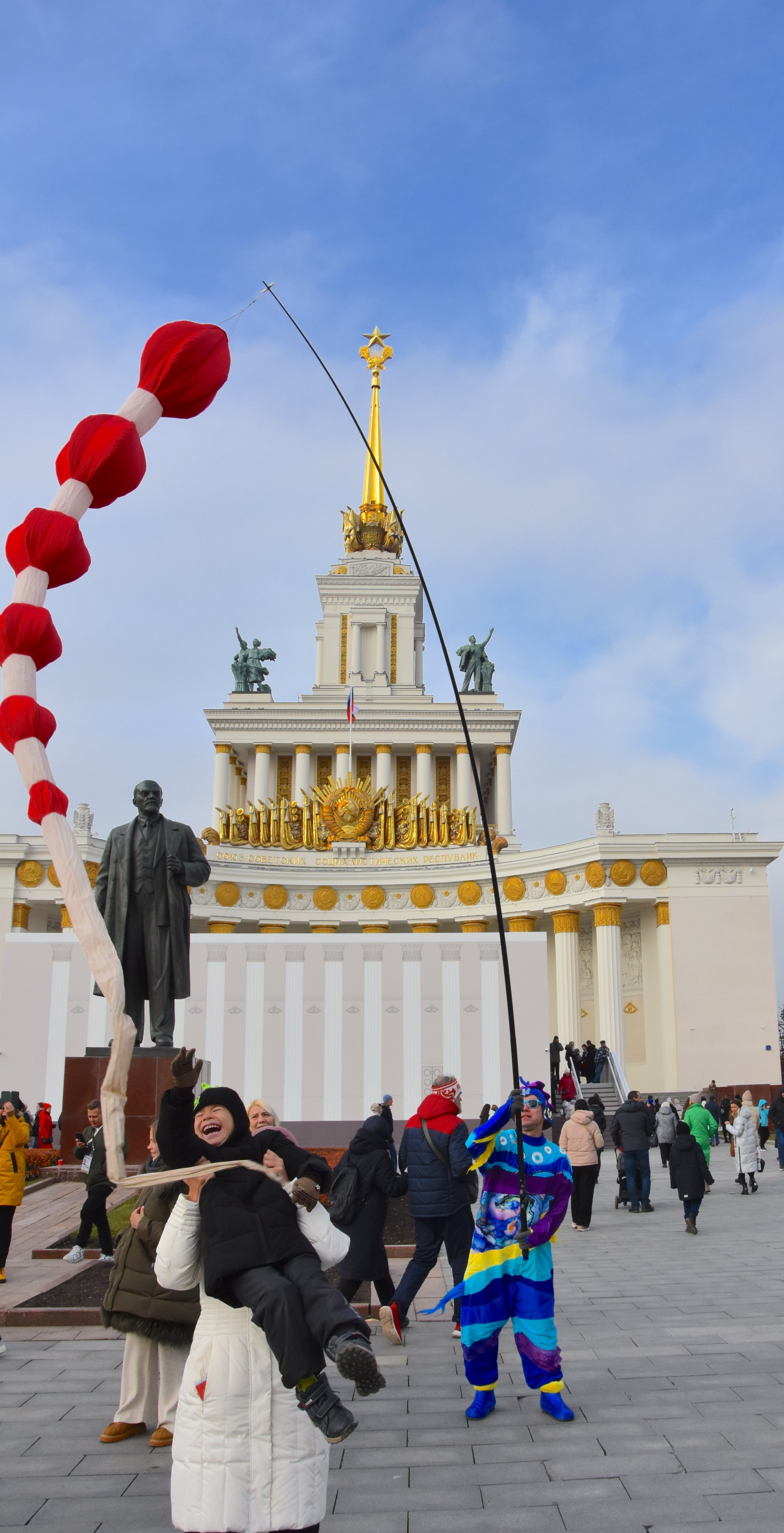 A happy child lifted up by his mother at VDNKh, Moscow, 2023