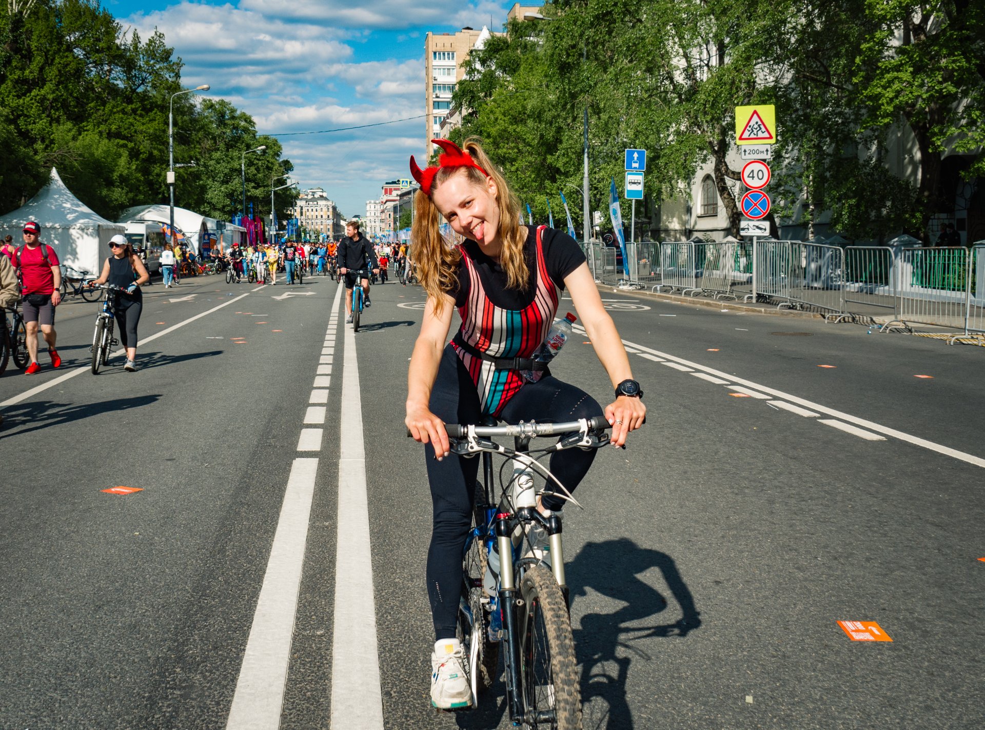 All participants of the cycling parade were in high spirits. Here, a nice naughty girl carrying a bottle of Russian mineral water "Saint Spring".