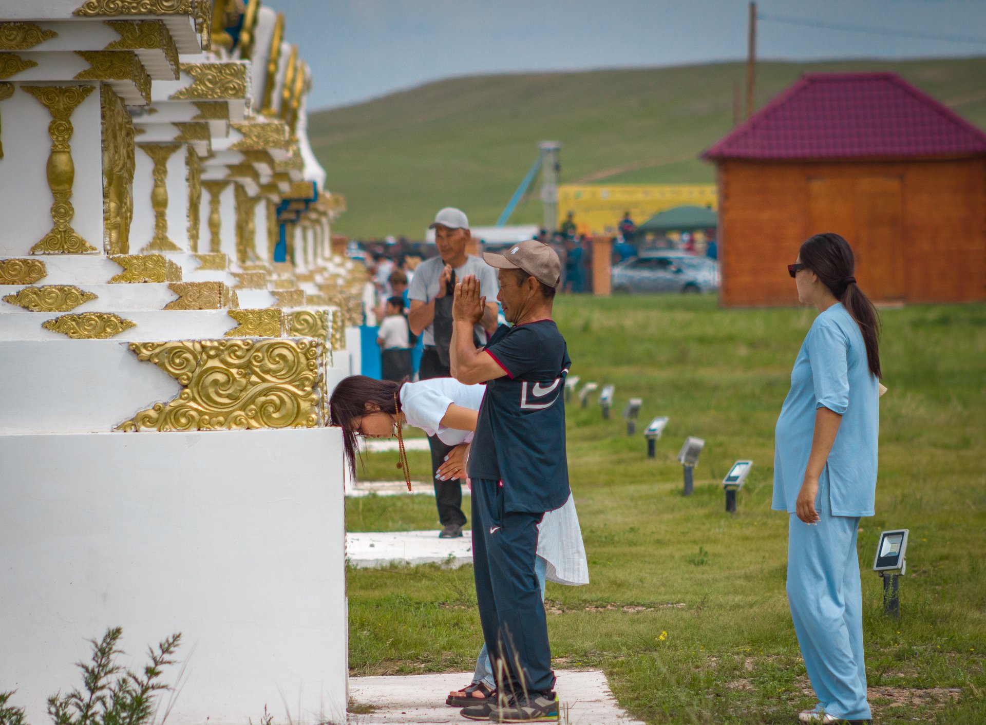 The parishioners of the datsan perform the sacred ritual of circumambulating the stupas.
