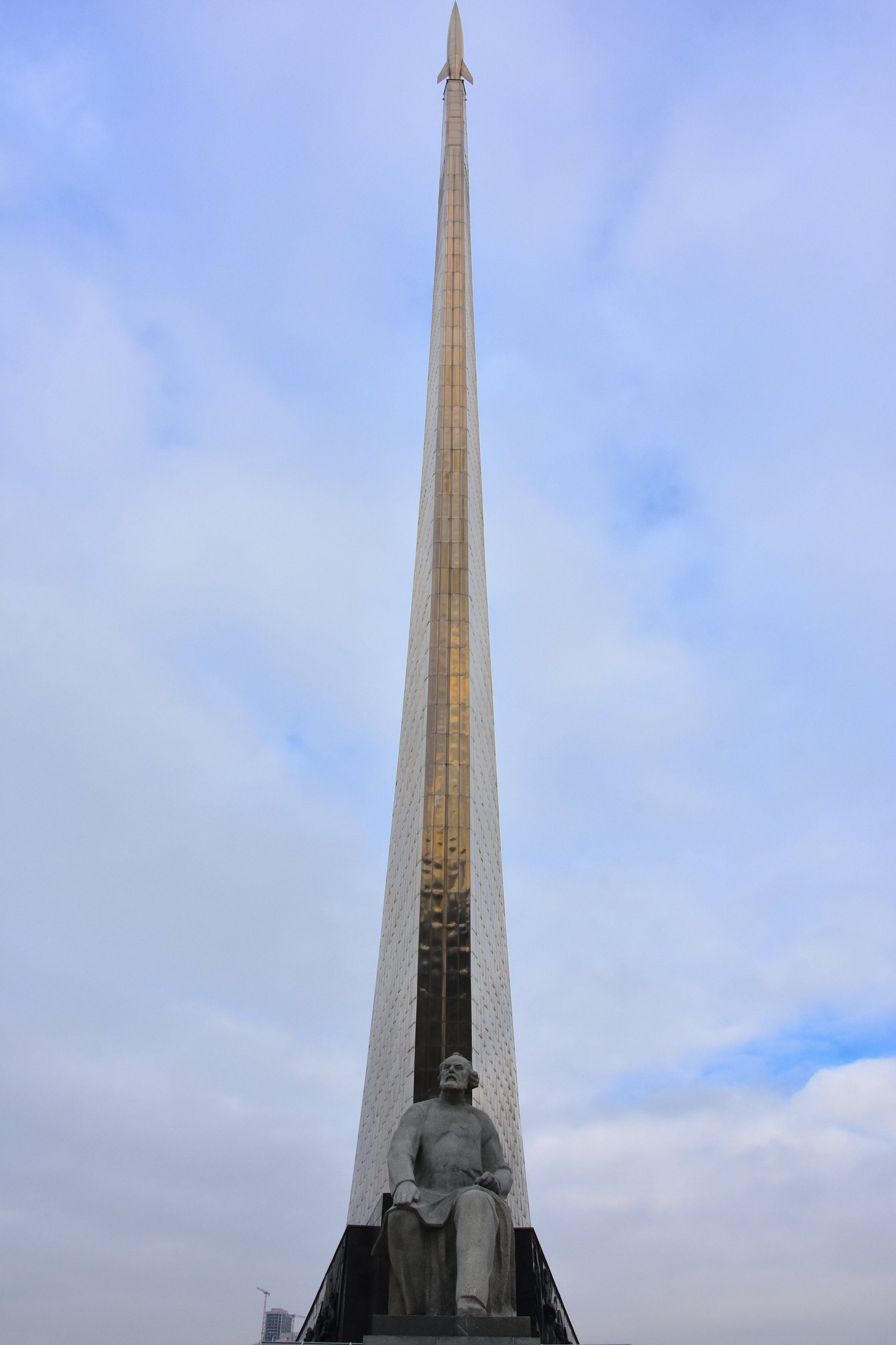 Statue of Konstantin Tsiolkovsky, often referred to as the father of astronautics and human spaceflight, in front of the Monument to the Conquerors of Space, Moscow, 2023.