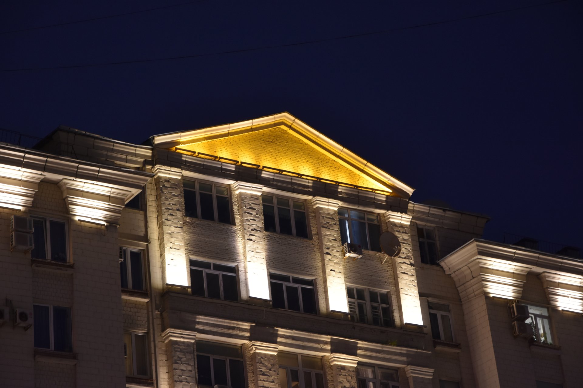 A building lit at night like a Greek temple, Moscow, 2023.