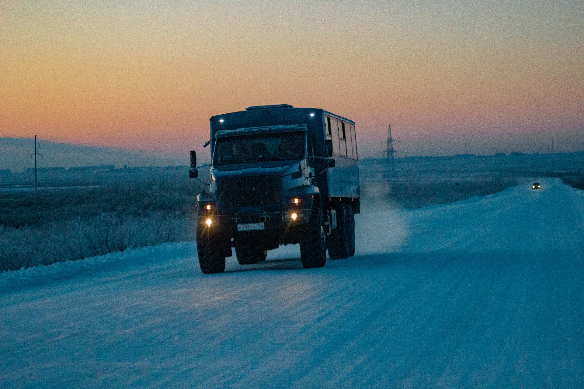 A truck carries mine workers along a winter road.