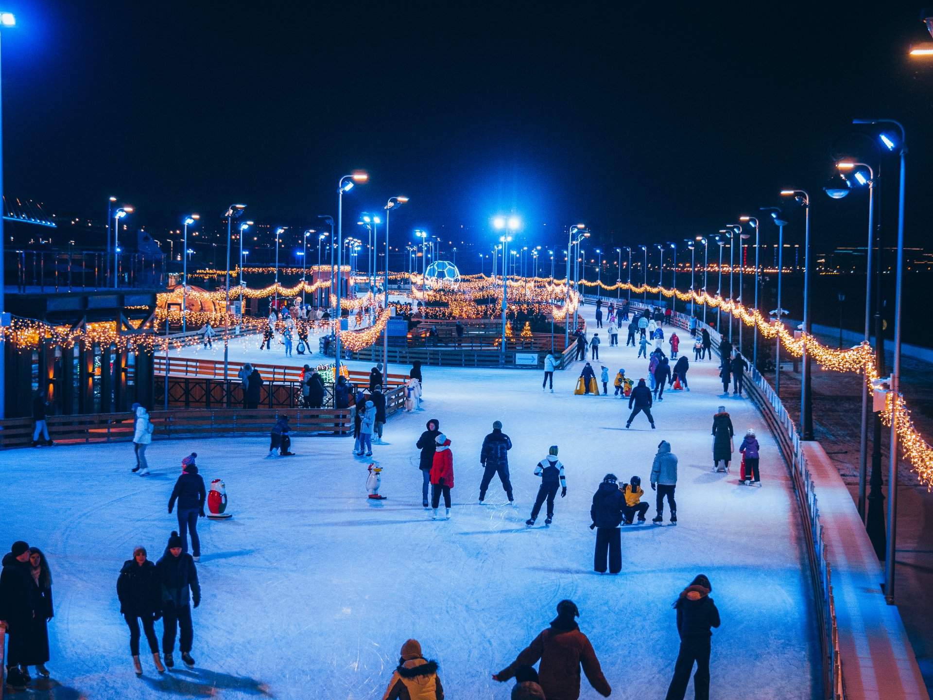 City residents and tourists come to appreciate the scale of the skating rink and have a good time.