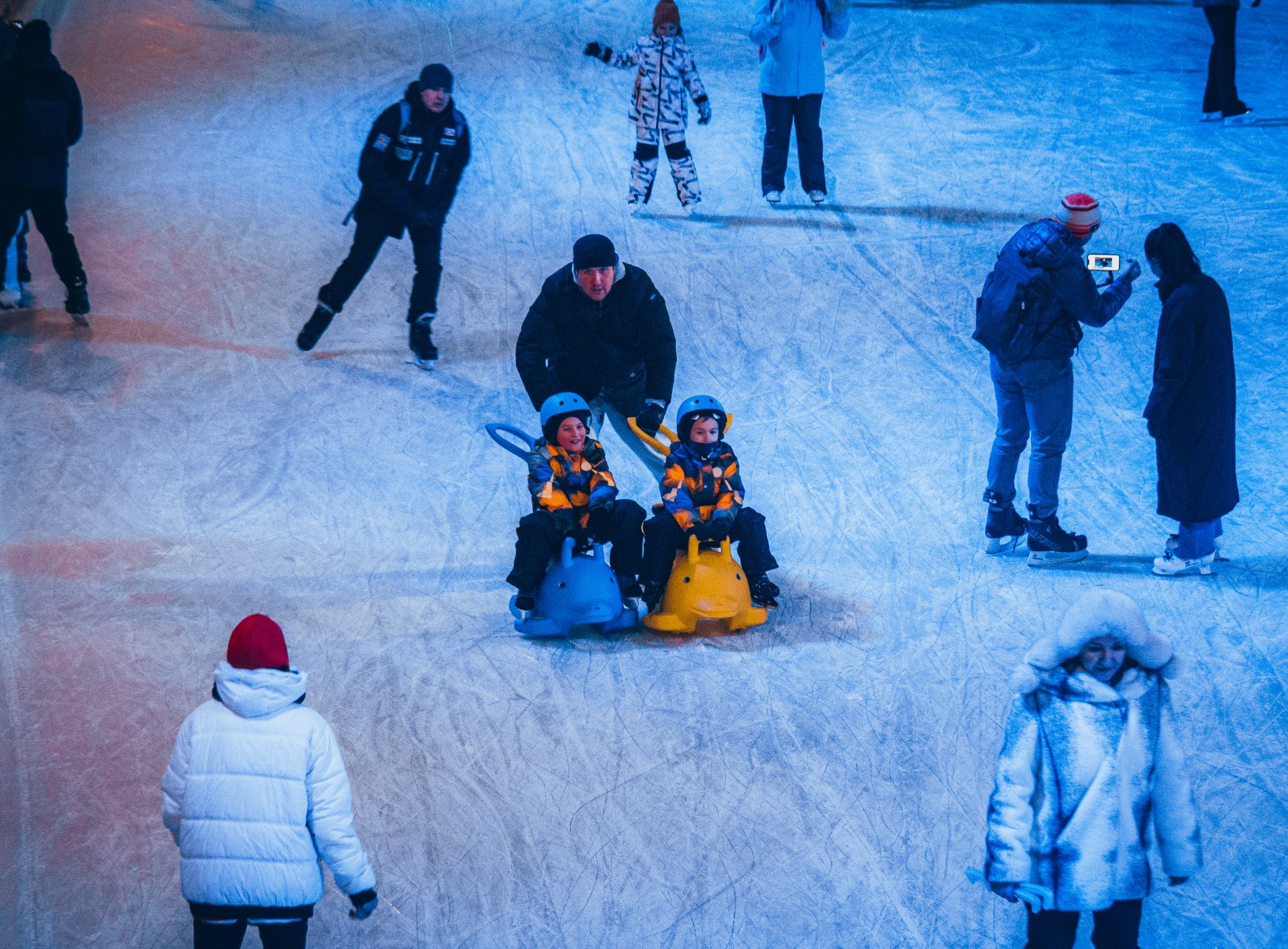 City residents and tourists come to appreciate the scale of the skating rink and have a good time.