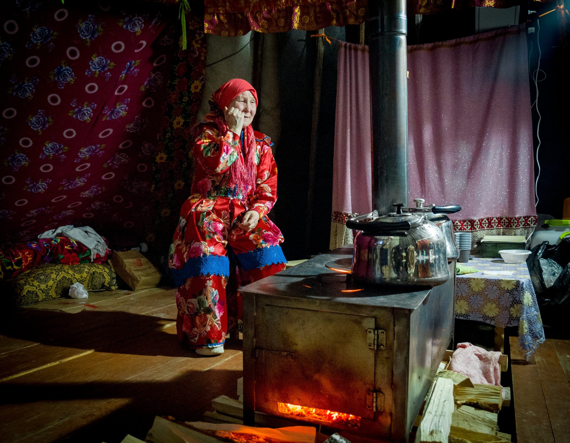 The stove is always lit inside the chum in winter. Traditionally, a woman is responsible for the comfort of the house.