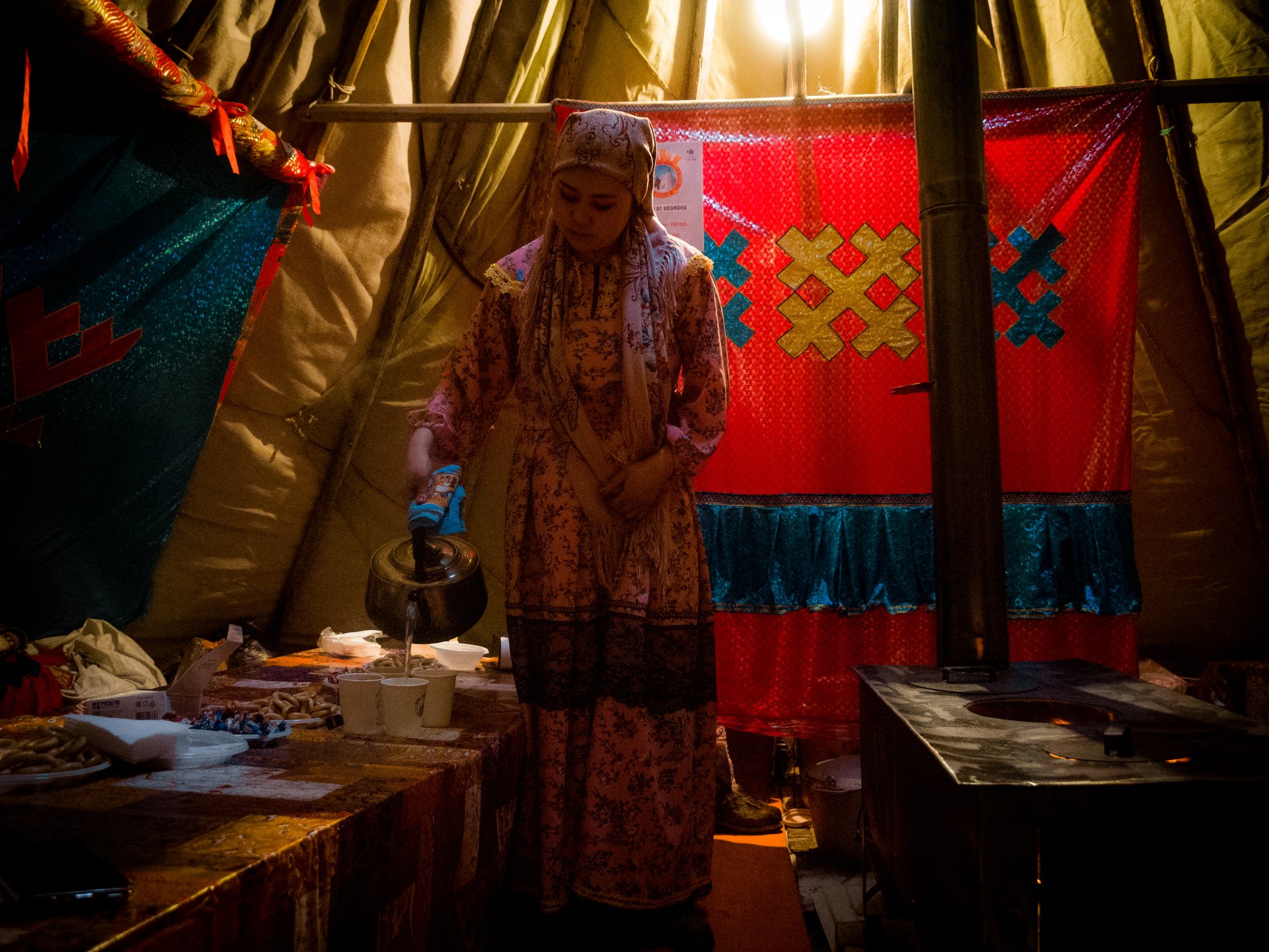 The stove is always lit inside the chum in winter. Traditionally, a woman is responsible for the comfort of the house.