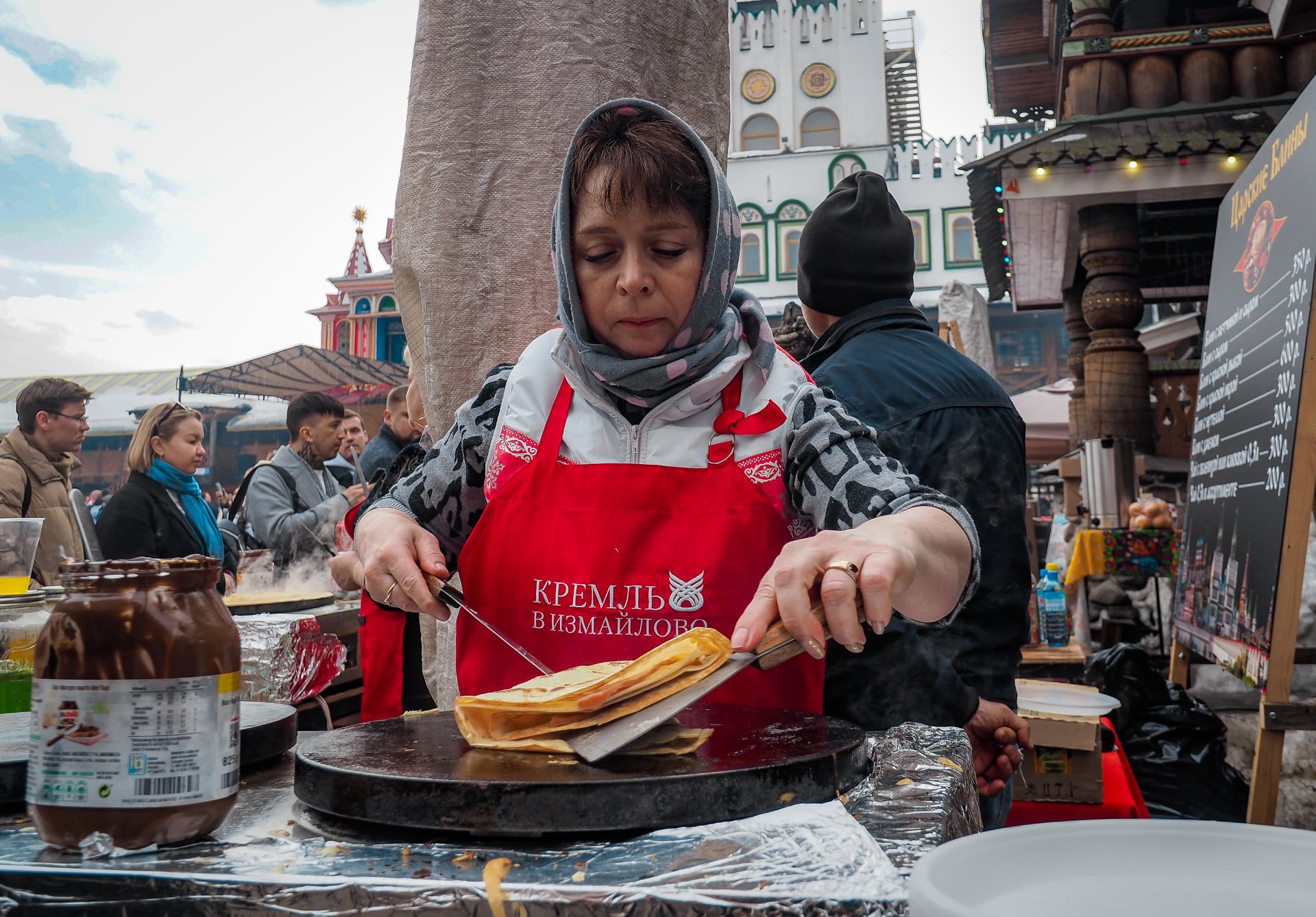 A woman bakes blyn, a traditional Russian dish for Maslenitsa.