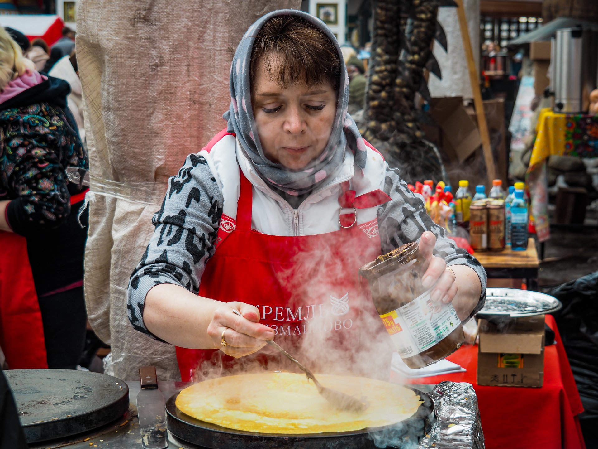 A woman bakes blyn, a traditional Russian dish for Maslenitsa.