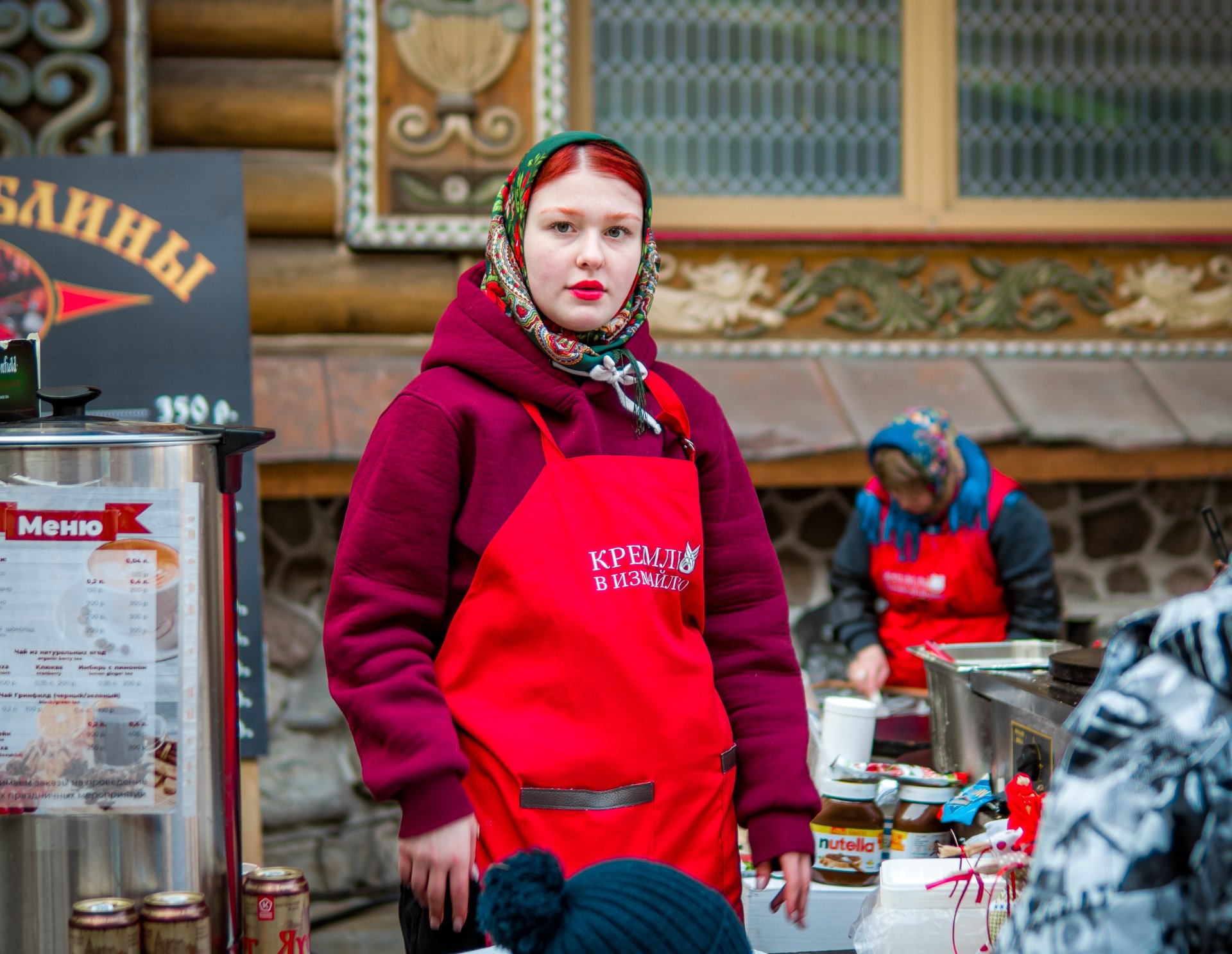 A young girl who treats the guests of the festival with tea.