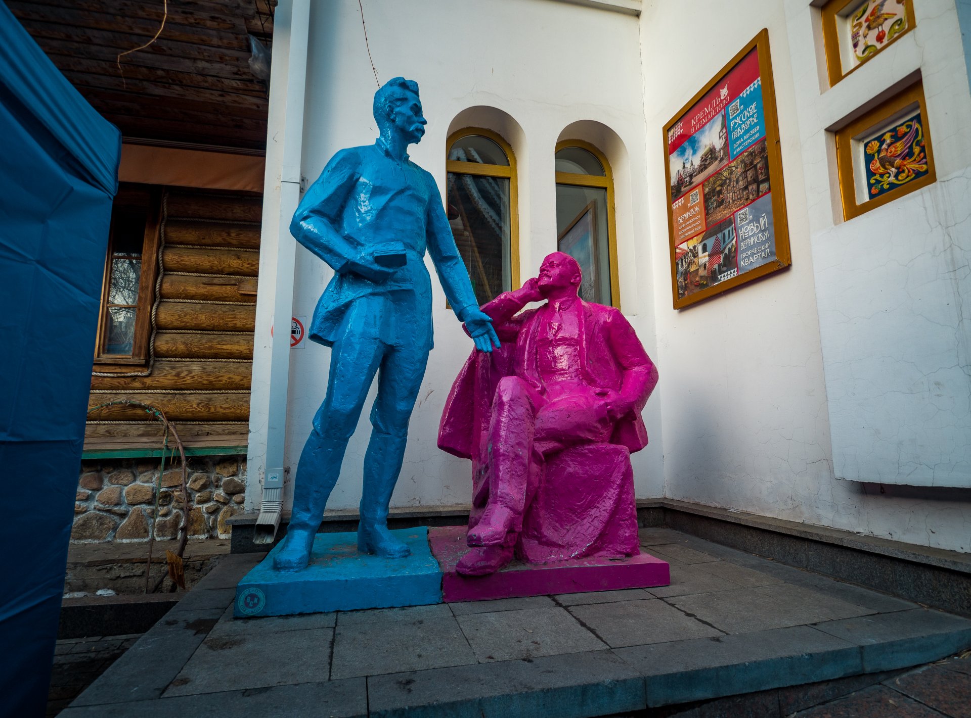 The sculptures of Lenin and Gorky, decorated in pink and blue, quietly watch the religious holiday from the corner.