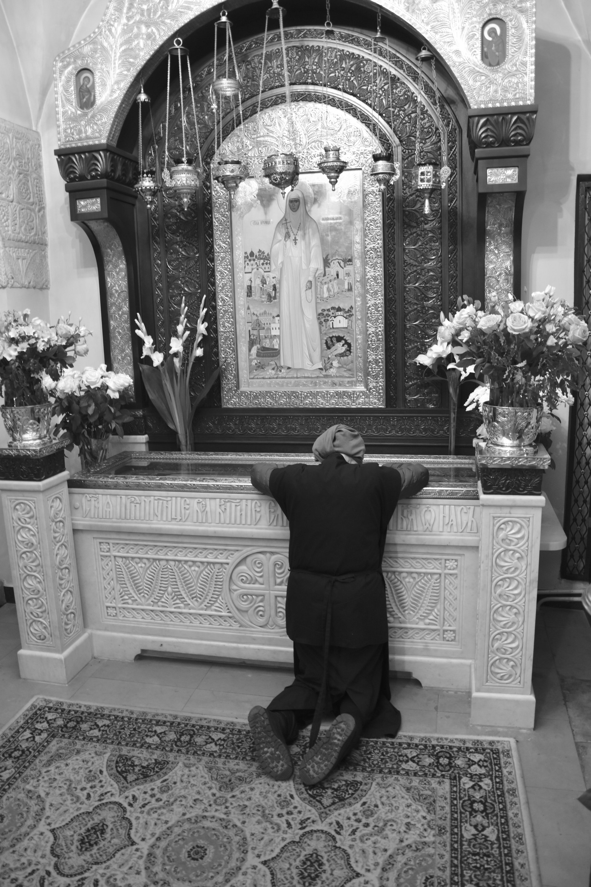 A woman praying in the chapel, Moscow, 2023
