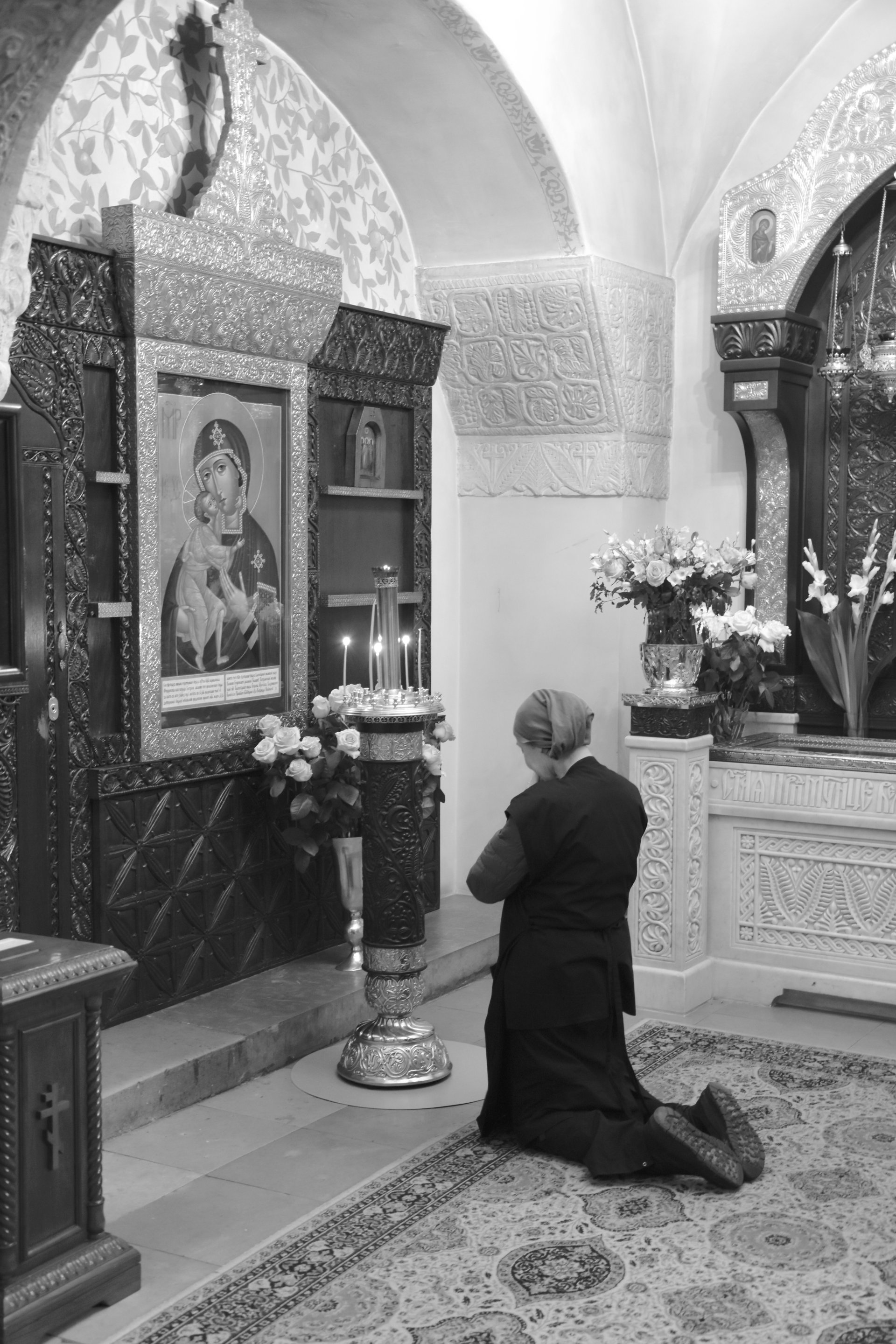 A woman praying in the chapel, Moscow, 2023