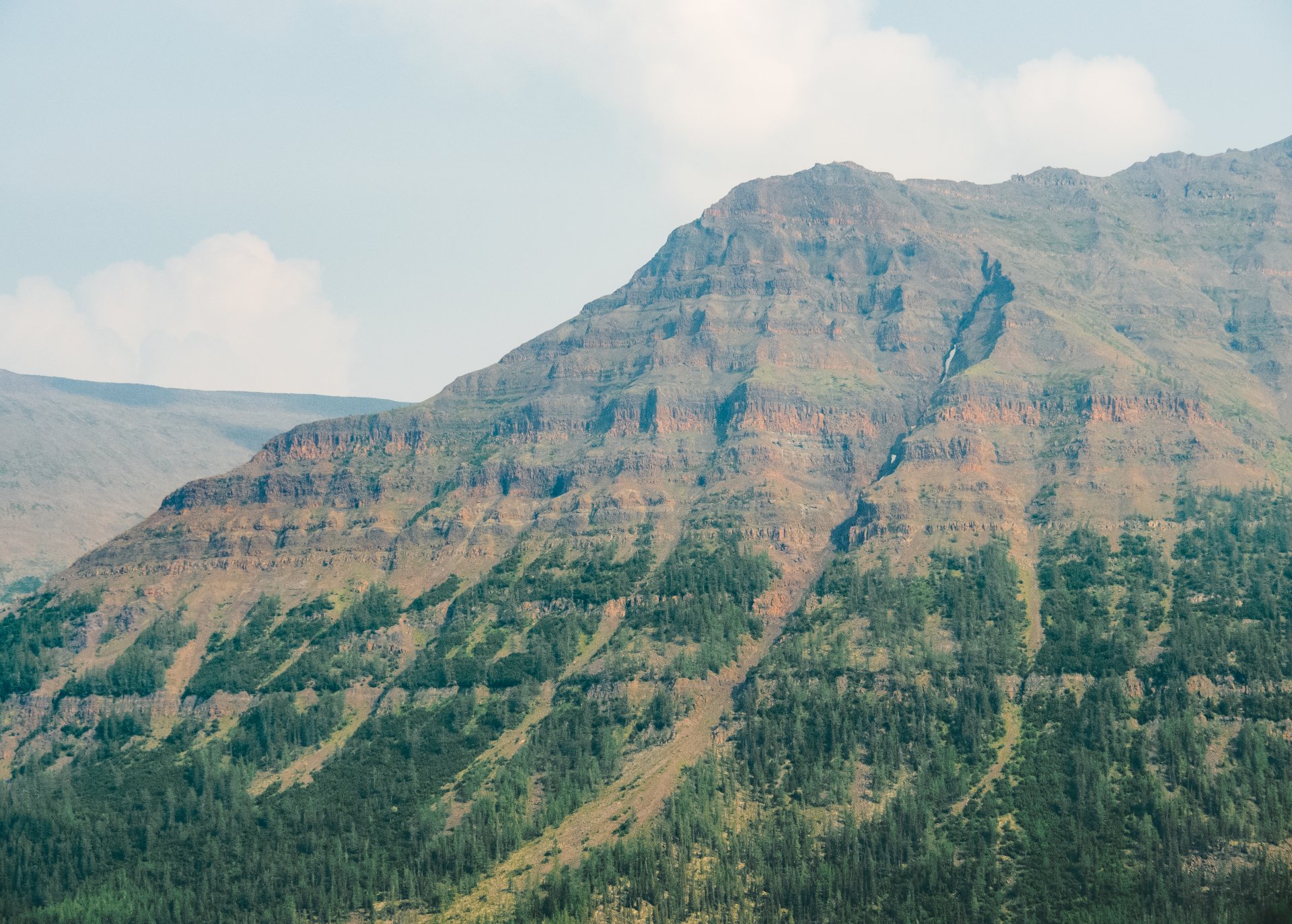 The Putorana plateau was formed after the eruption of a supervolcano 250 million years ago.. The frozen lava formed basalt rocks, which are often called Siberian traps (mountains without peaks).